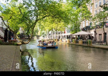 People enjoying on hand made floating raft boat in Oudegracht canal in the city centre of Utrecht, the Netherlands Stock Photo
