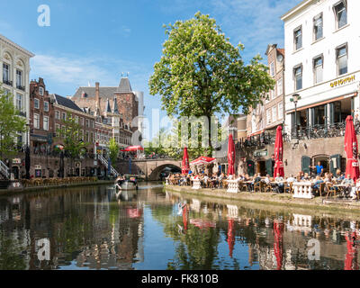 Oudaen Castle and people on outdoor terrace of restaurants alongside Oudegracht canal in the city of Utrecht, Netherlands Stock Photo