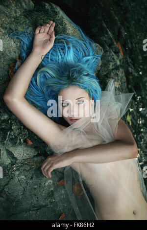 Water lady posing on stream stones . Fantasy and myth Stock Photo