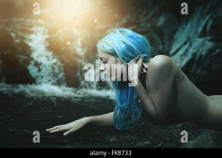 Water nymph surrounded by magical lights . Fantasy and myth Stock Photo