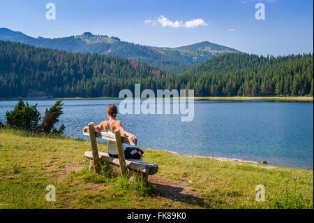 Wooden bench at Black Lake in Durmitor, Montenegro Stock Photo
