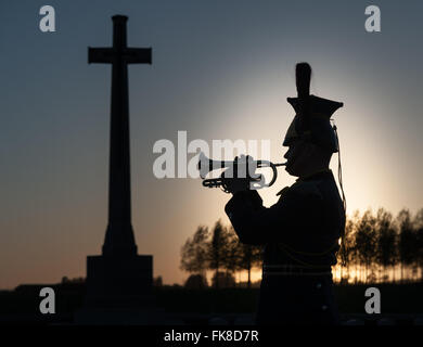 The Divisional Cemetery, Ypres, Belgium - A Military bugler playing The Last Post at sunset in memory of fallen soldiers of World War One Stock Photo