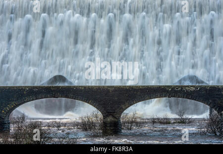 Caban Coch Dam in the Elan Valley Mid Wales with water running over the top after heavy rainfall Stock Photo