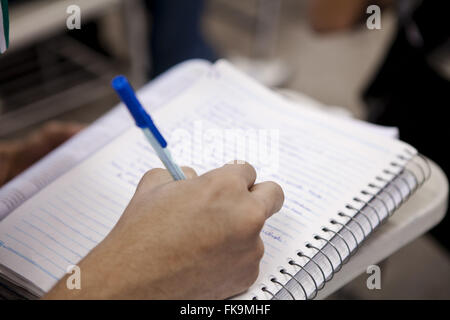 Student writing in notebook in the State School of Vocational Education Paul Petrola Stock Photo