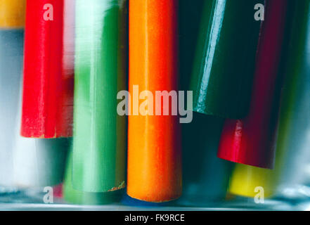 Close-up of colorful drawing pencils in a glass jar Stock Photo