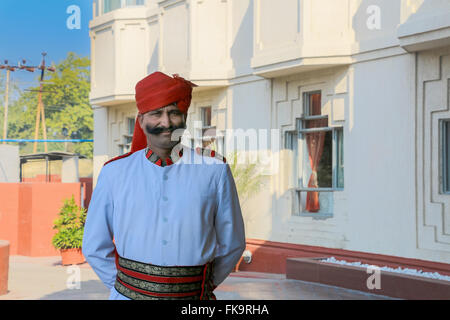 Indian man with red  turban wearing traditional dress outside hotel near Fatehpur Sikri, Uttar Pradesh, India, Asia Stock Photo