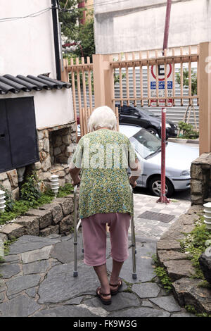 Lady walks using walker in Liberdade Stock Photo