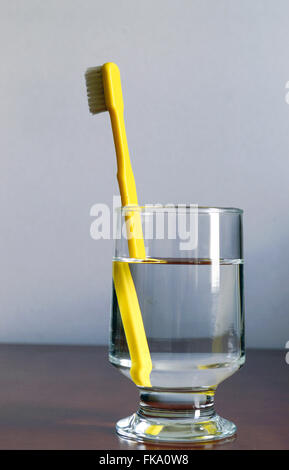 Toothbrush in glass of water - refraction phenomenon Stock Photo