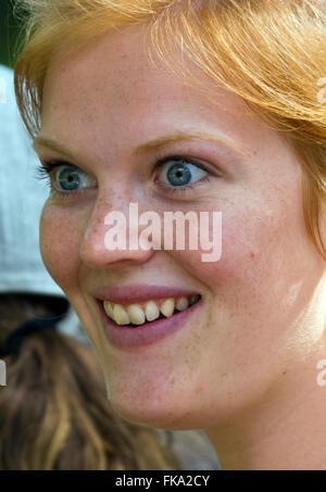 Red haired girl with freckles looking amazed whilst watching the Bird show at Australia Zoo, Quuensland, Australia Stock Photo