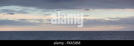 View of Calm Seas and Distant Clouds at Sunset from the Deck of a ...