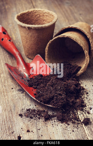 garden tools, peat pots, ground  for planting  on the old wooden background Stock Photo