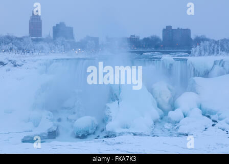 The American Falls almost completely frozen during a cold winter in Niagara Falls, Niagara County, New York, USA. Stock Photo