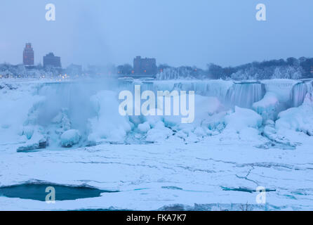 The American Falls almost completely frozen during a cold winter in Niagara Falls, Niagara County, New York, USA. Stock Photo