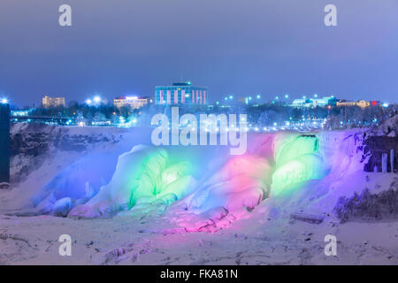 The American Falls illuminated at dusk in Niagara Falls, Niagara County, New York, USA. Stock Photo