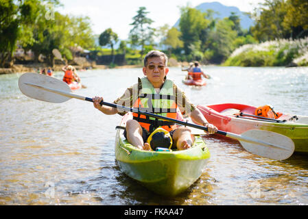 Senior man paddling kayak Stock Photo