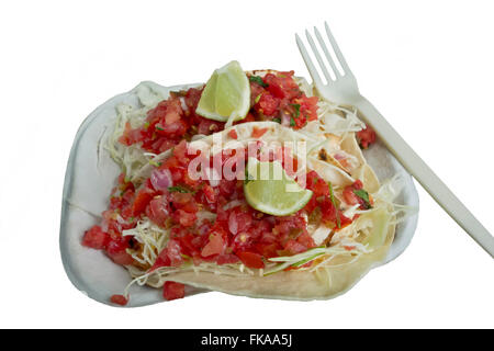 Takeaway or takeout fish tacos with tomato salsa and limes.  From Tacofino food truck in Tofino.  On white background. Stock Photo