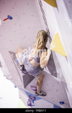 Climbers take part in a bouldering competition at Bloc climbing centre, Bristol. Stock Photo