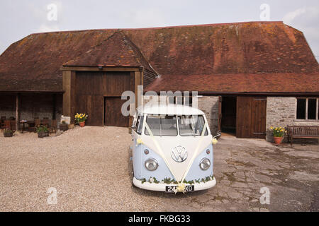 VW Campervan,VW,Volkswagon,at,old,barn,wedding,reception,Dorset,England,UK,wedding campervan,van,marriage,split screen, classic, Stock Photo