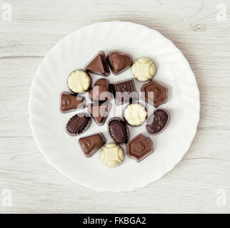Various belgian pralines on the white plate. Sweet food theme. Stock Photo
