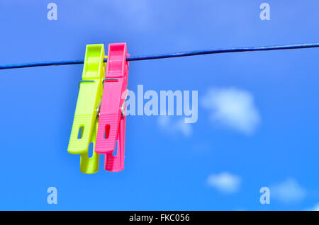 Plastic clothes pegs on washing line. Stock Photo