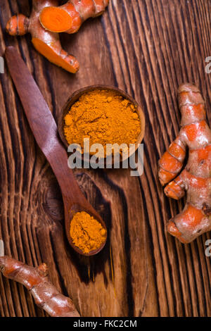 An old wooden table with Turmeric (selective focus, close-up shot) Stock Photo