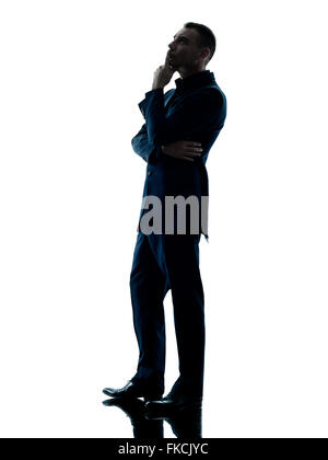 one caucasian business man standing thinking silhouette isolated on white background Stock Photo