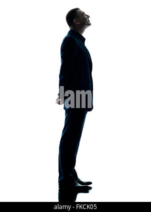 one caucasian business man standing profile silhouette isolated on white background Stock Photo