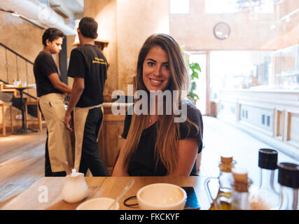 Young woman sitting in cafe, Mumbai, India Stock Photo