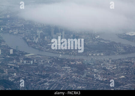 London UK.8th March 2016. UK Weather: An aerial photograph of Canary Wharf partially obscured by clouds on a cold day as temperatures reach 5 degrees celsius Credit:  amer ghazzal/Alamy Live News Stock Photo