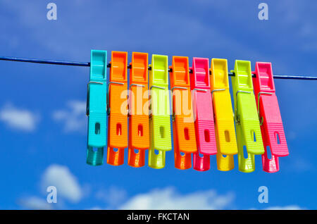 Plastic clothes pegs on washing line. Stock Photo