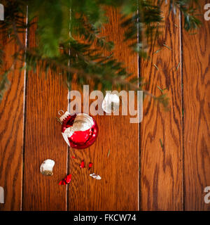 Broken christmas ornament on floor Stock Photo