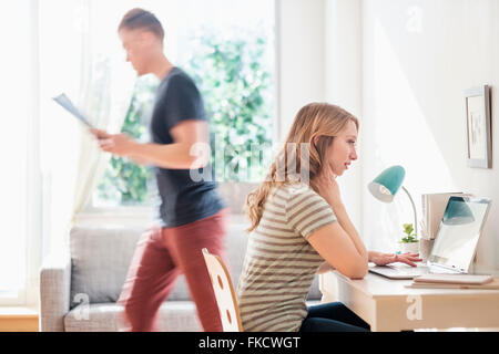 Side-view of young couple working at home Stock Photo