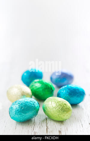 Close up of an assortment of chocolate Easter eggs on a rustic wooden background. Stock Photo