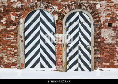 Two striped doors on a brick facade of the old fort Stock Photo
