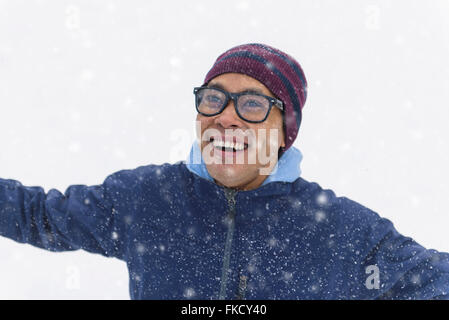 Mid adult man standing on snow Stock Photo