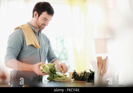 Man preparing food in kitchen Stock Photo