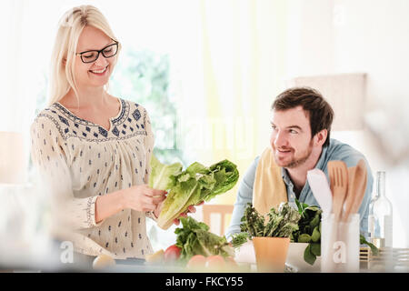 Man and woman in kitchen, smiling Stock Photo