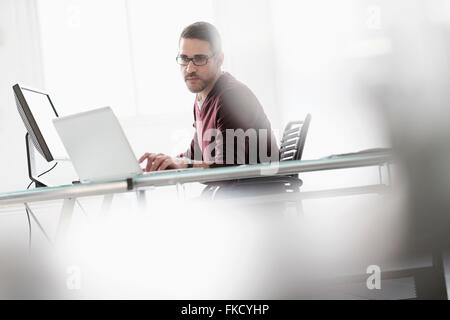 Man using laptop in office Stock Photo