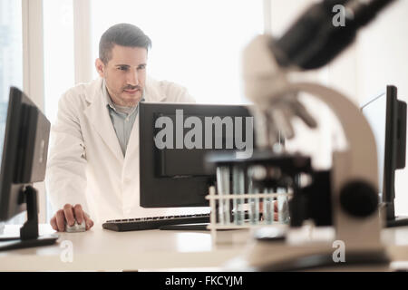 Man using computer in laboratory Stock Photo