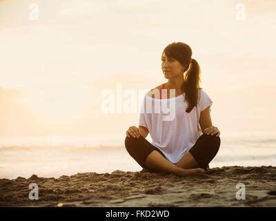 Young woman sitting on beach