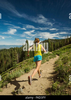 Mature woman running in mountains Stock Photo