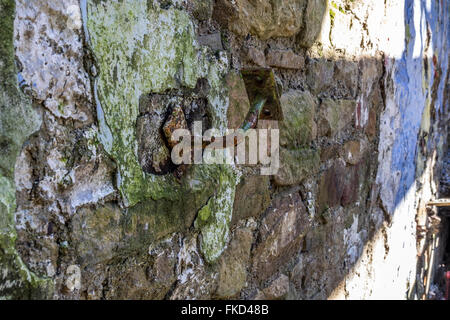 A metal bracket on the wall which originally held a handrail down the steps Stock Photo