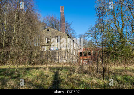 Abandoned and derelict factory in a poor state of repair with windows missing Stock Photo