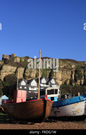 Traditional wooden fishing boats on the Stade with the East Hill Railway funicular in the background, Hastings, East Sussex, UK Stock Photo