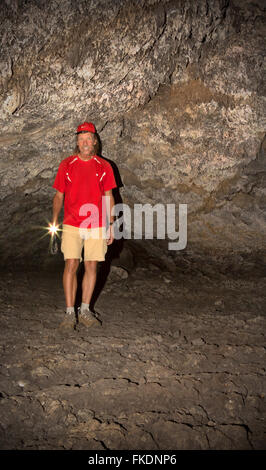 IDAHO - Visitor exploring the Buffalo Caves, lava tubes located on the Broken Top Loop in Craters of the Moon National Monument. Stock Photo