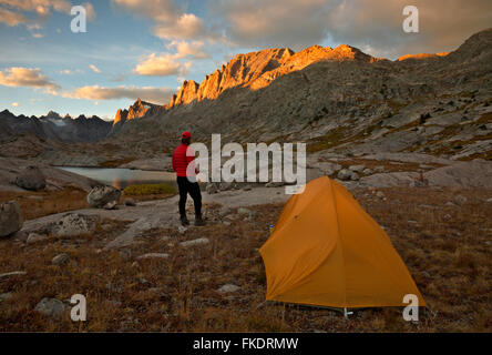 WY01228-00...WYOMING - Watching the sunset from a campsite near a small lake in Titcomb Basin area of the Wind River Range. Stock Photo