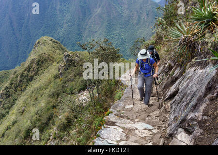 Two hikers walking on Inca trail of Machu Picchu, Cusco Region, Urubamba Province, Machupicchu District, Peru Stock Photo