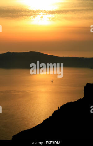 Sunset over Aegean Sea with sailboat, Oia, Santorini, Greece Stock ...