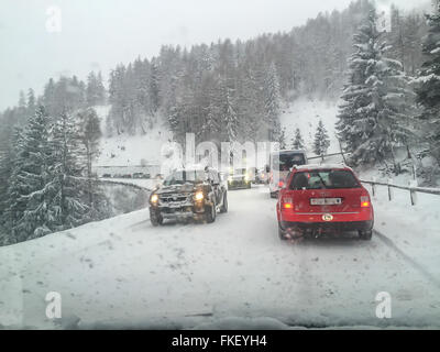 Driving in winter through the mountains. Alpine roads covered with snow and ice, slush Stock Photo