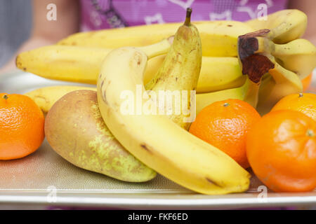 Bananas pears and tangerines on a metal tray. Stock Photo